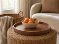 Round Tray Dávid on a woven ottoman with a ceramic bowl of clementines