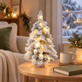 Tabletop Tree Janka, snowy mini christmas tree with warm lights on a side table