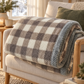 Knit Blanket Tatiana – coffee check on a linen armchair