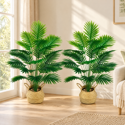 Pair of feathery artificial palms in woven baskets in a bright living room