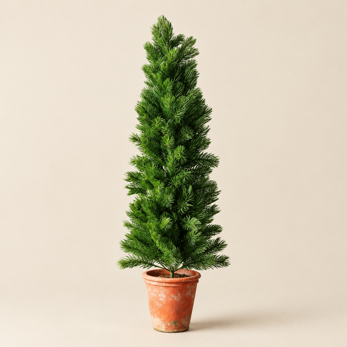 Christmas Tree Gejza – slim faux pine tree in terracotta pot, studio shot