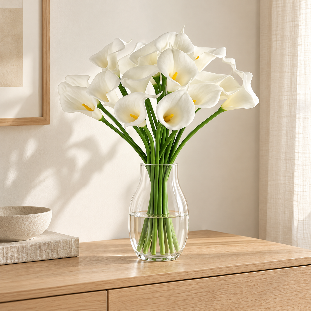 Calla Lily Stems Ľubomíra – in a clear glass vase on an oak sideboard