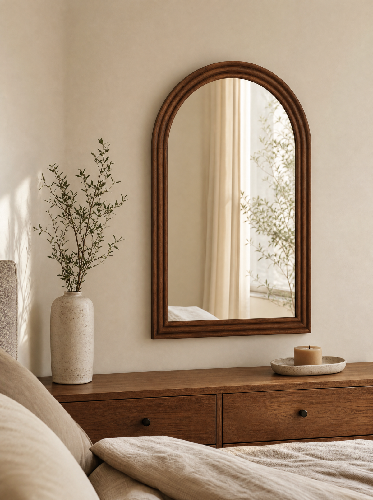 Mirror Michal in Brown wood finish, arched frame above a bedroom dresser