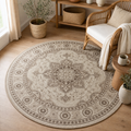 Round Rug Roman, beige and taupe medallion pattern, styled in a sunlit boho living room with a rattan chair