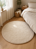 Round Rug Natália in cream/ivory flannel pile styled beside a bed in a warm bedroom corner