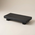 Pedestal Riser Katarína in Black, footed wooden riser on a neutral background