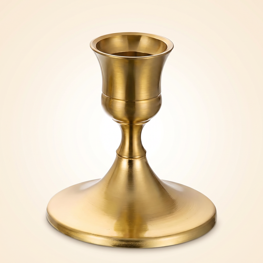 Single brass gold taper candlestick holder on a clean studio background