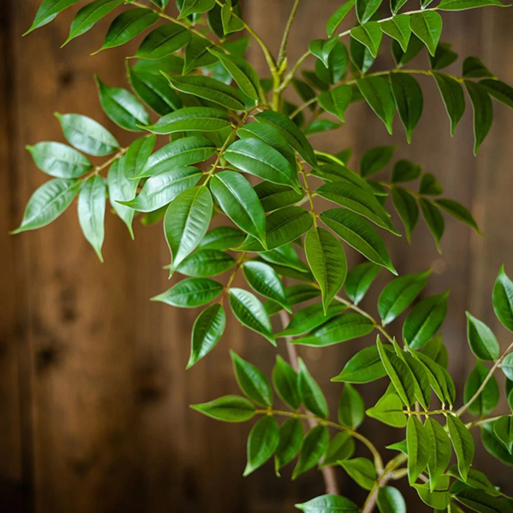 Close-up of green faux leaf branch leaves