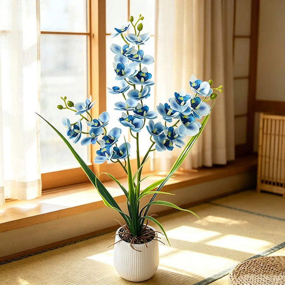 Artificial blue orchid in a white pot on a sunlit windowsill