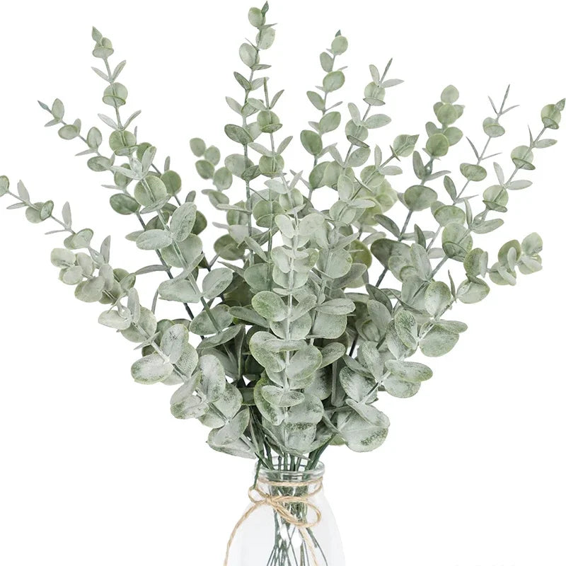 Grey green eucalyptus stems in a glass jar with twine