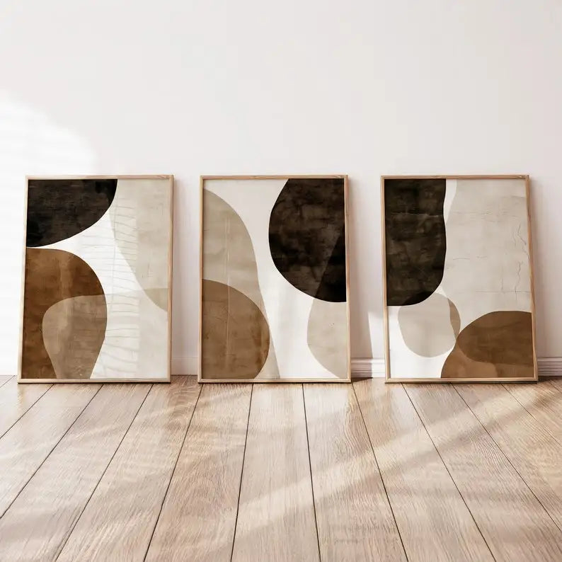 Three Umber Organic abstract canvas prints leaning against a wall