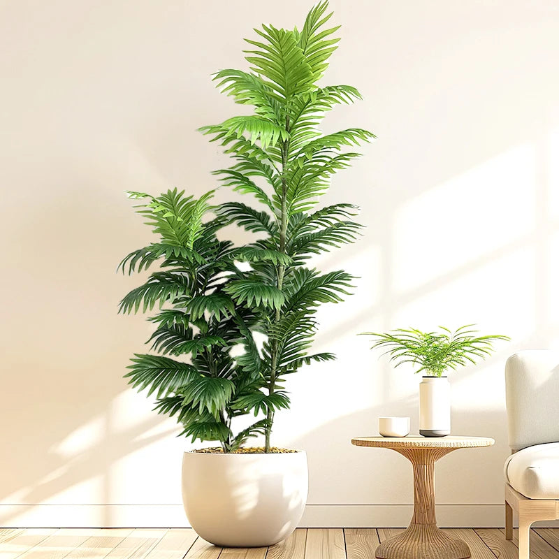 Artificial areca palm Anežka in a white pot by a side table