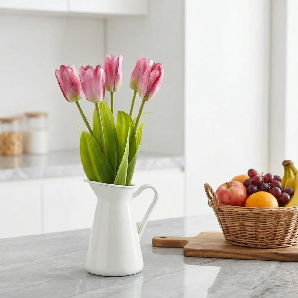 Pink real-touch tulips in a white jug on a kitchen counter