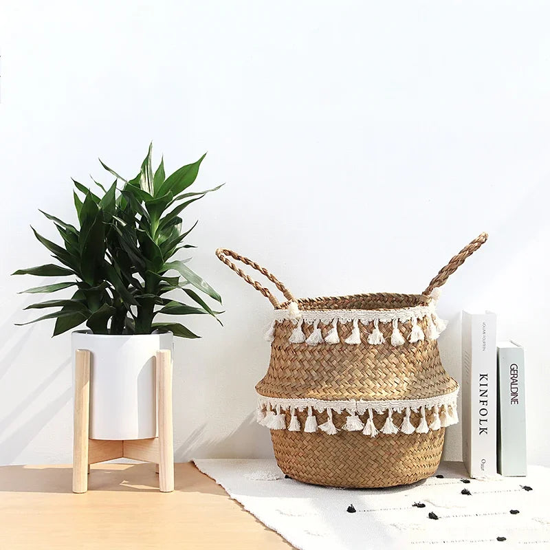 Seagrass belly basket used as a plant cover next to a wooden plant stand