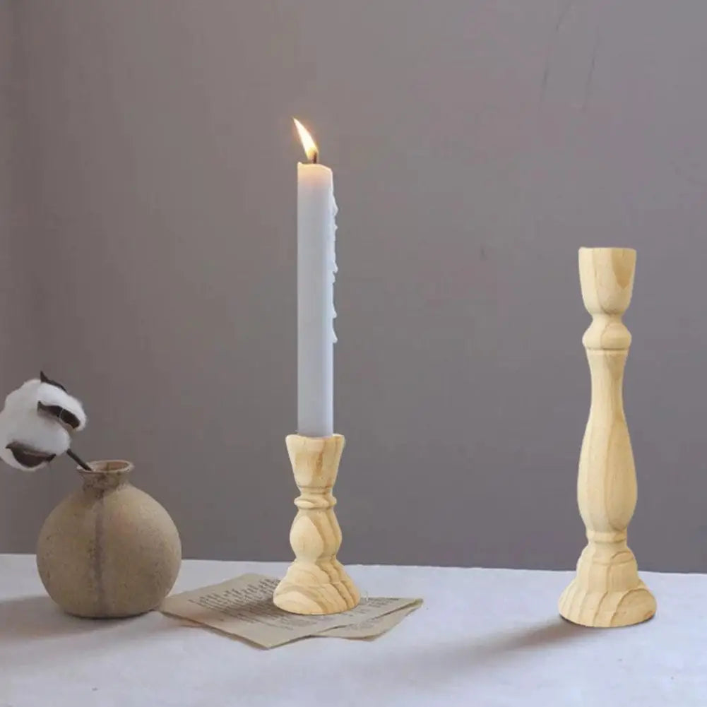 Candlestick Tomáš in natural wood with a lit white candle