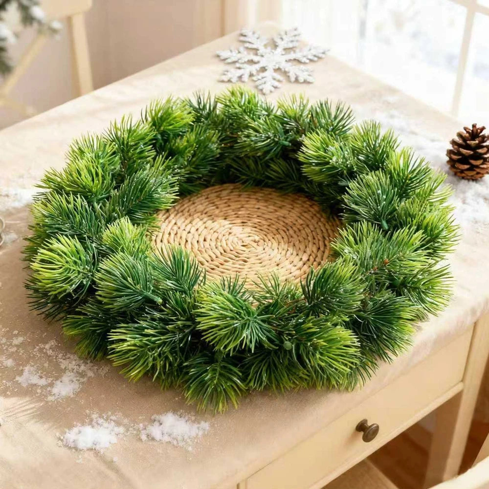 Green pine needle sprigs arranged as a wreath
