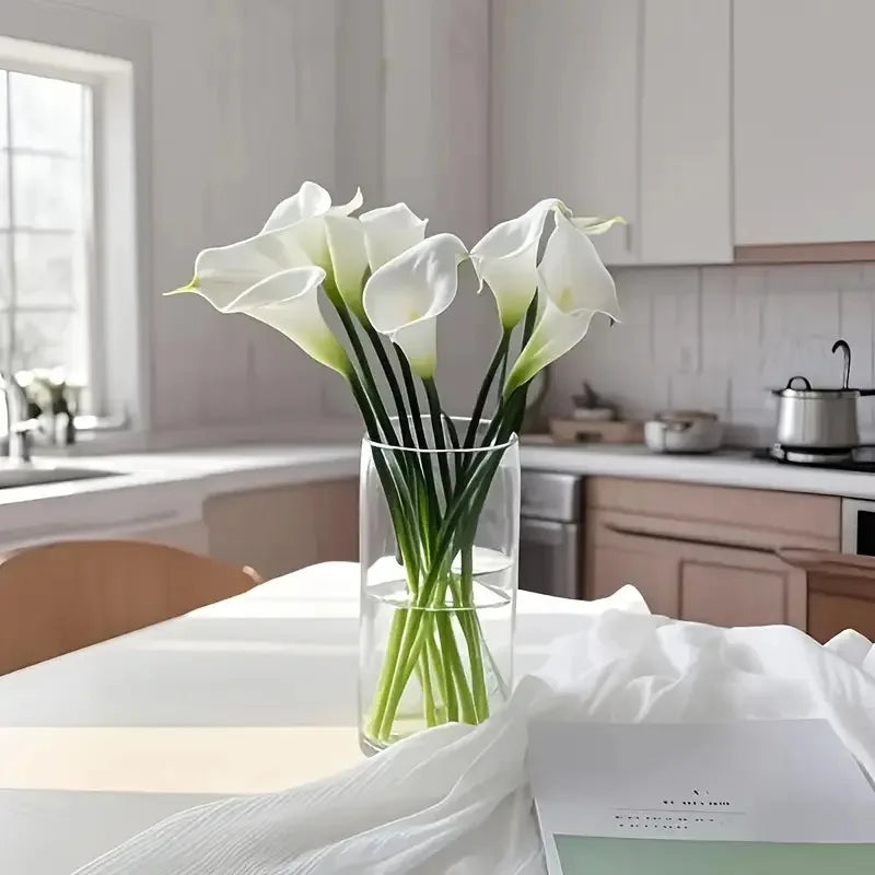 White calla lilies in a glass vase in a bright kitchen