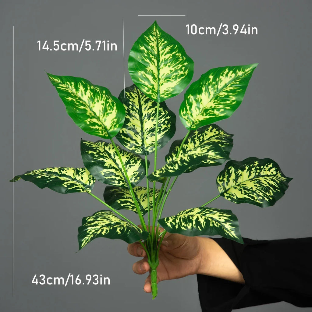 Speckled leaf faux plant held in hand with size measurements