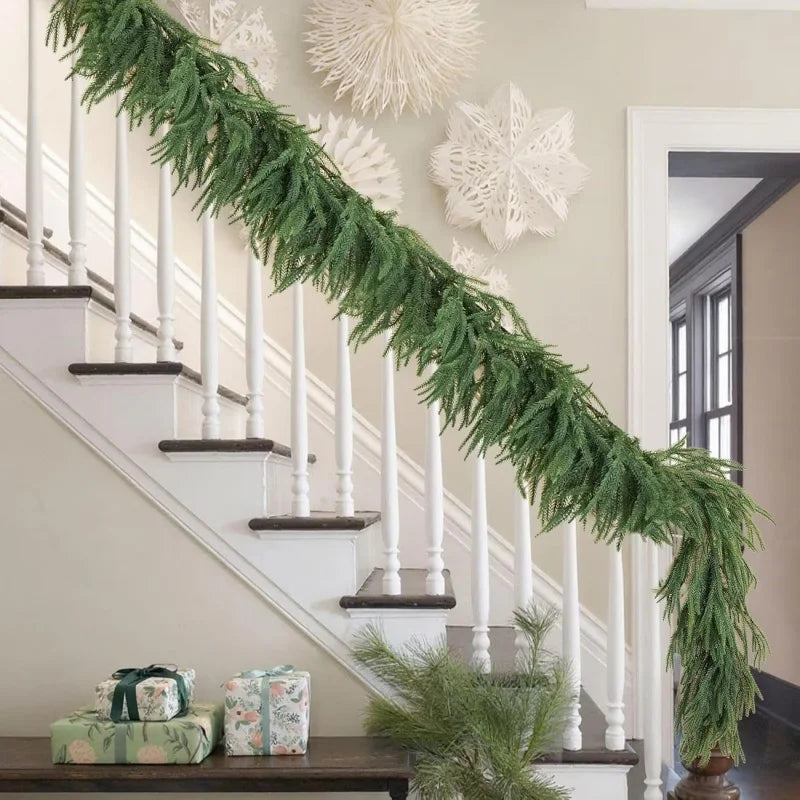 Norfolk pine garland Juliána draped along a white staircase banister