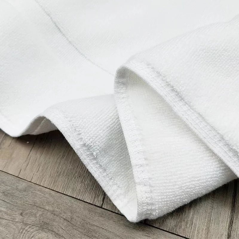 Close-up of the thick white cotton terry weave of Bath Mat Jarmila