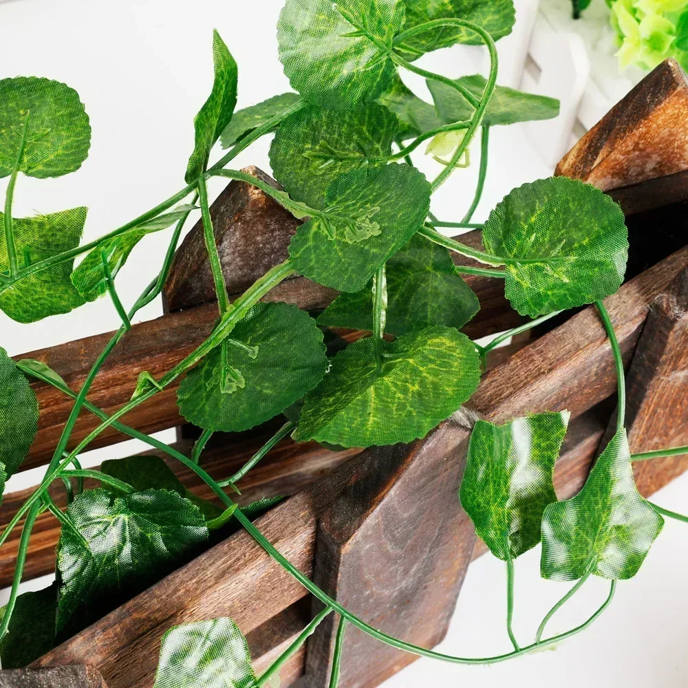 Close-up of faux ivy leaves on a wooden branch