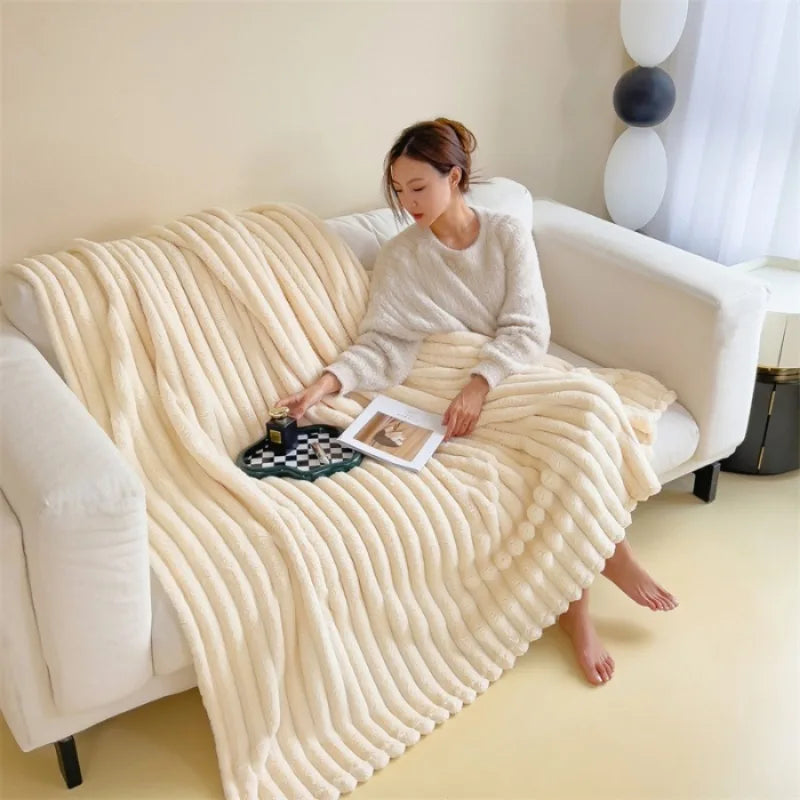 Throw Blanket Klaudia, ribbed faux fur in cream on a sofa