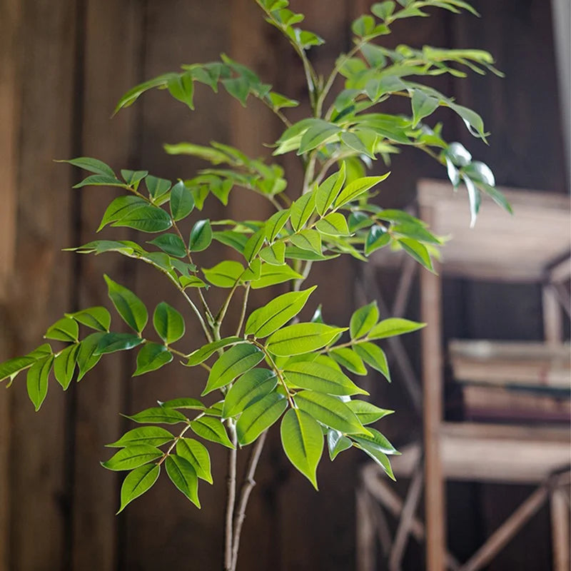 Faux leaf branch with fresh green leaflets on branching twigs