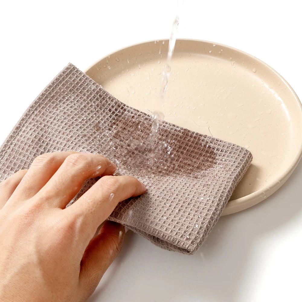 Kitchen Towels Vlasta, a taupe waffle towel drying a plate