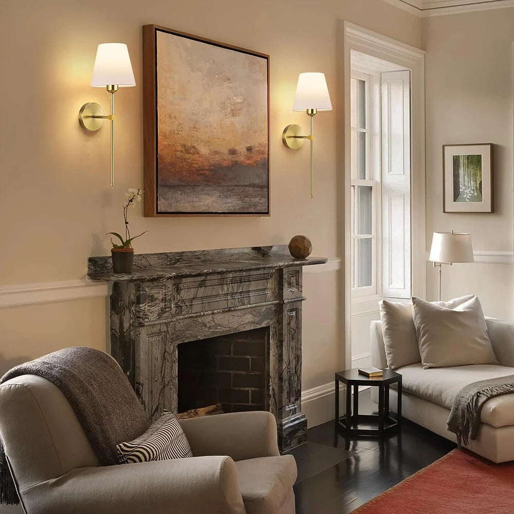 Wall Sconces Mirka beside a fireplace in a calm living room