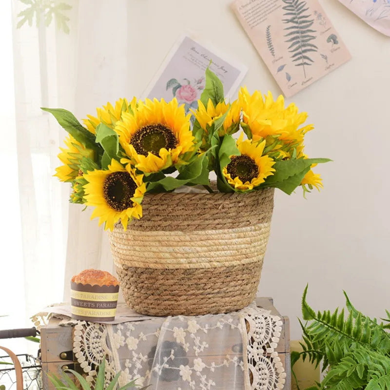 Grass planter basket with a cream band holding sunflowers