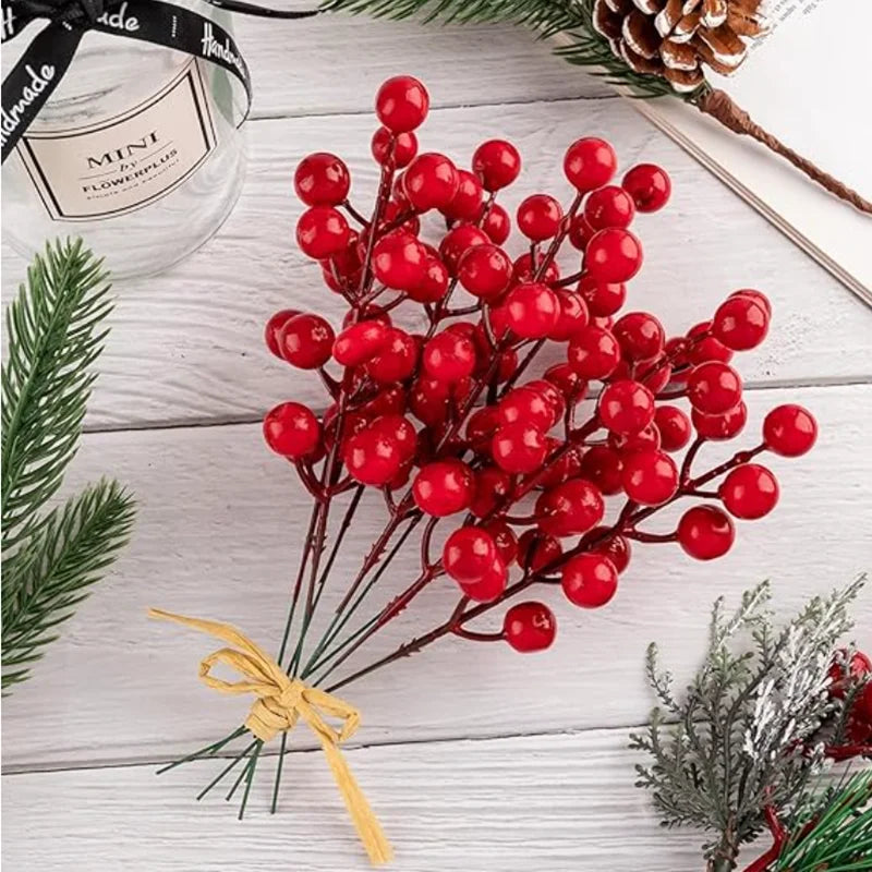 Bunch of red Christmas berry stems tied with raffia