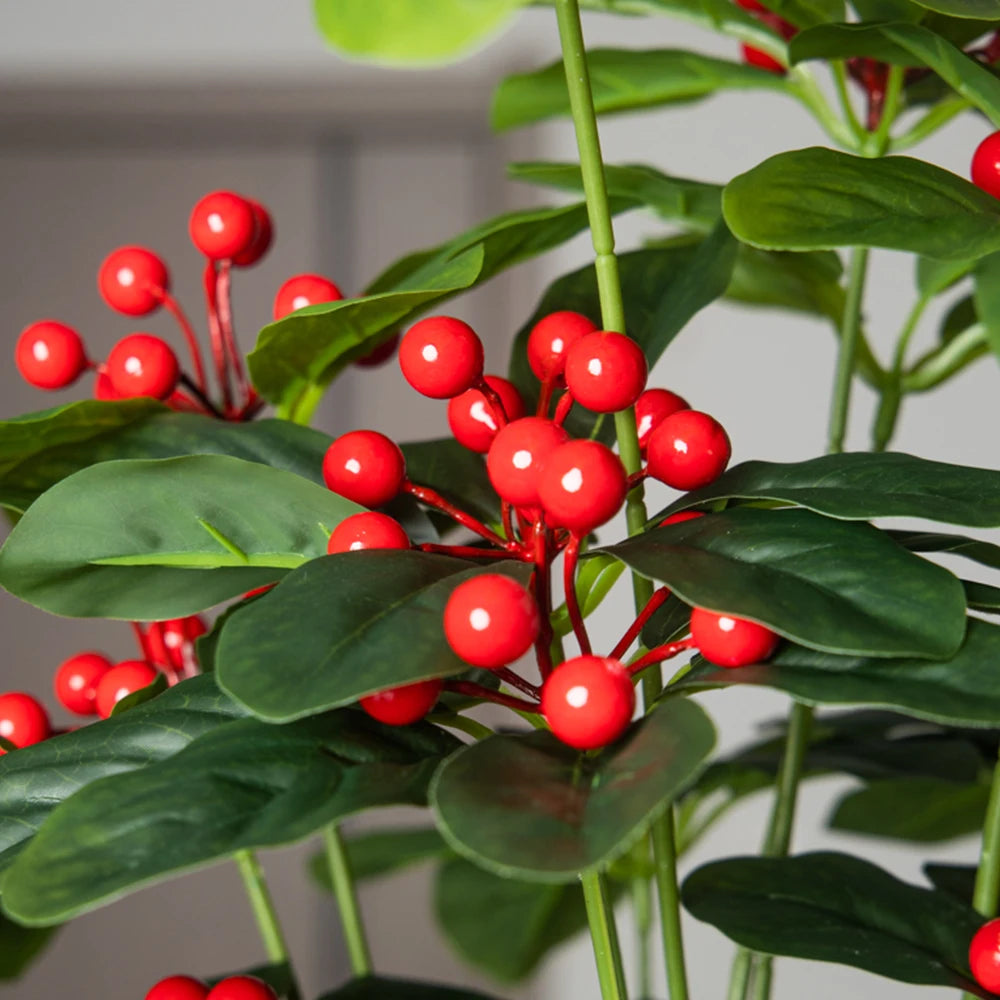 Close-up of artificial red berries on green leaves