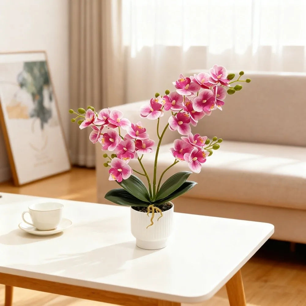 Artificial pink butterfly orchid in a white pot on a coffee table