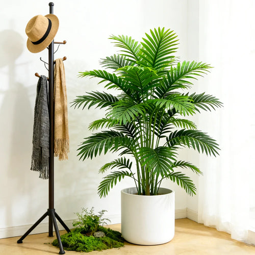 Artificial feathery palm Berta in a white pot in a bright hall