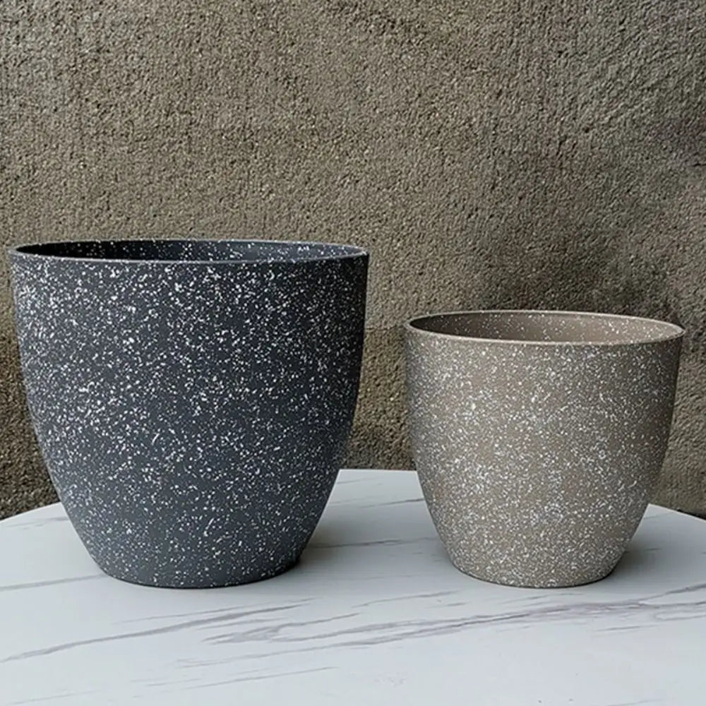 Stone-look planters Ignác in dark grey and taupe on a marble table