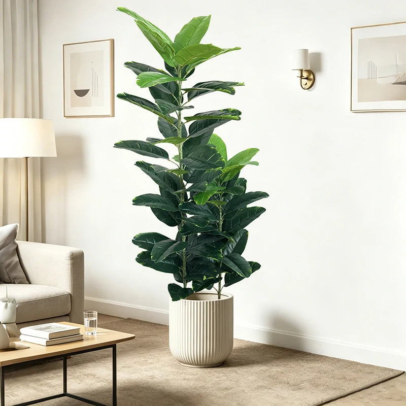 Artificial fiddle-leaf fig Anežka beside a sofa and floor lamp