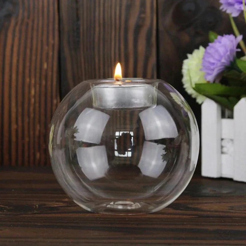 Round clear glass tealight holder on a dark wooden table