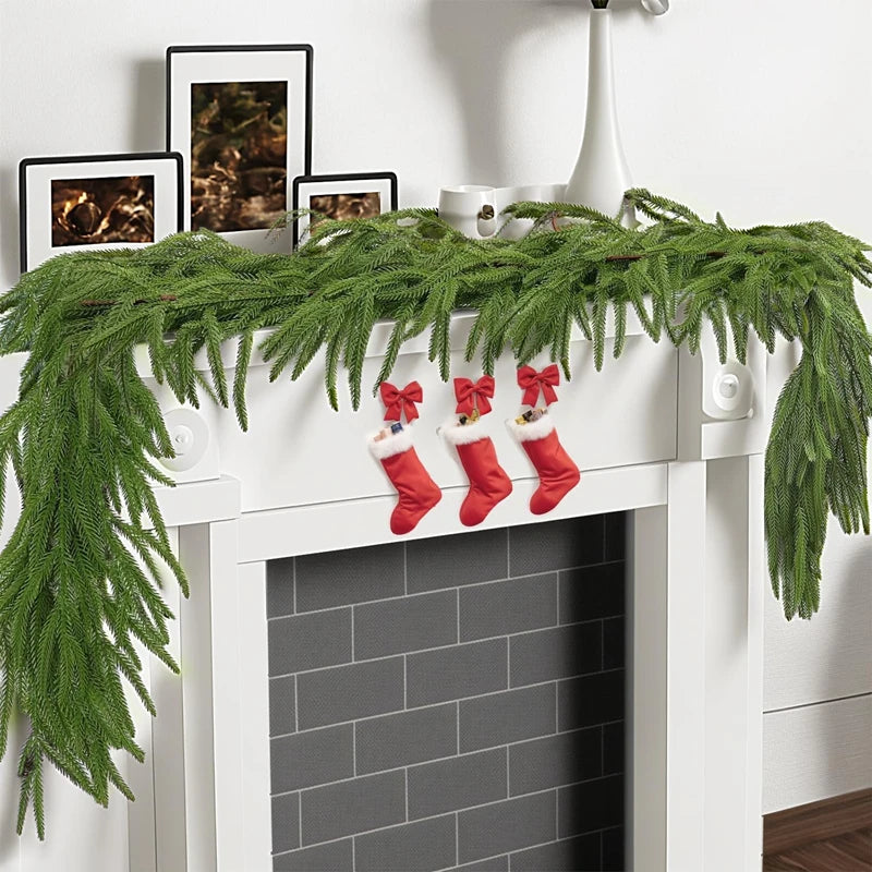 Pine Garland Viktória – garland on a white fireplace mantel