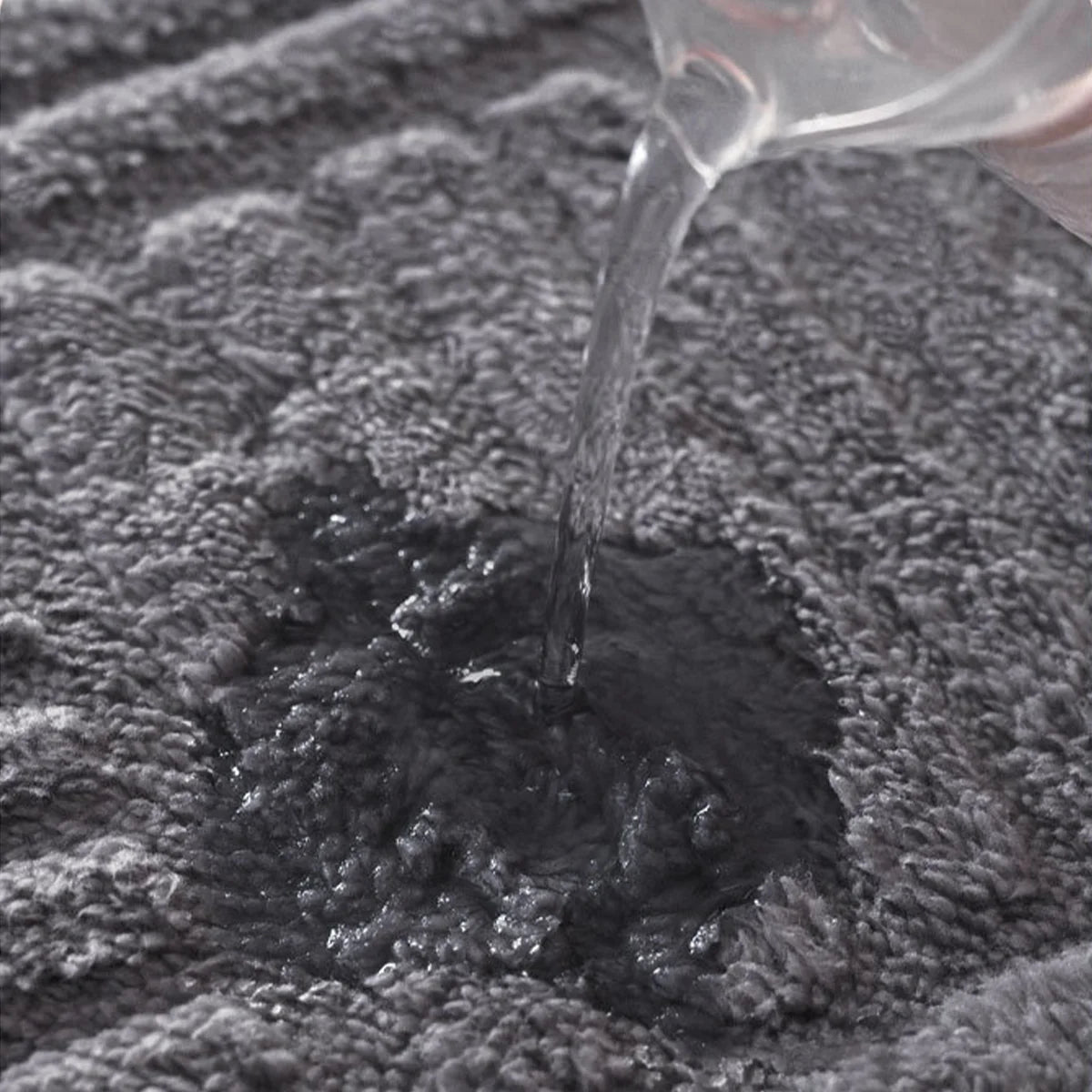 Water soaking into the soft pile of bath mat Silvia