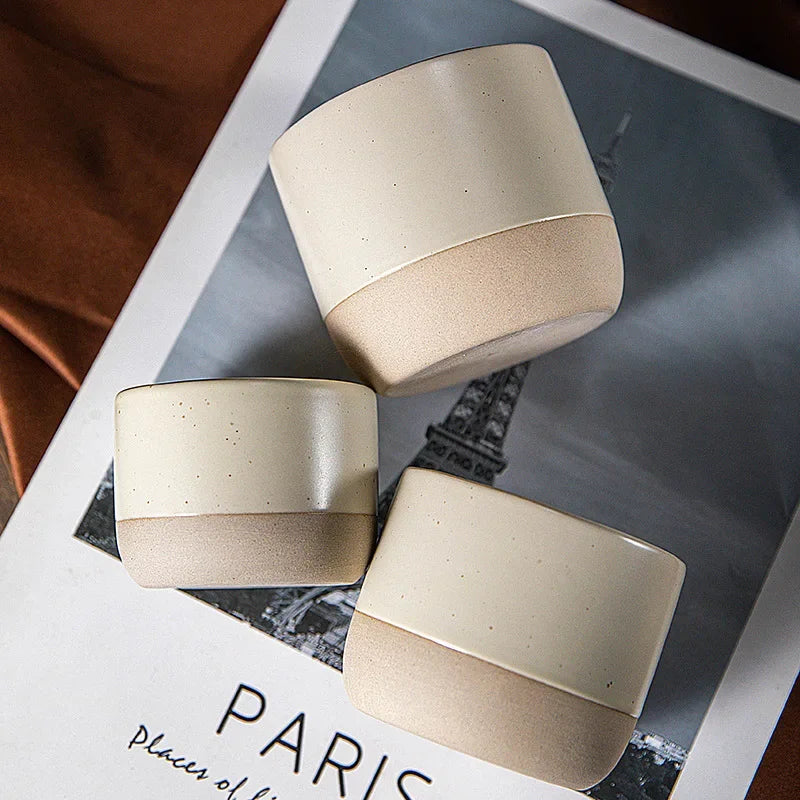 Three cream ceramic cups with an unglazed natural base, seen from above
