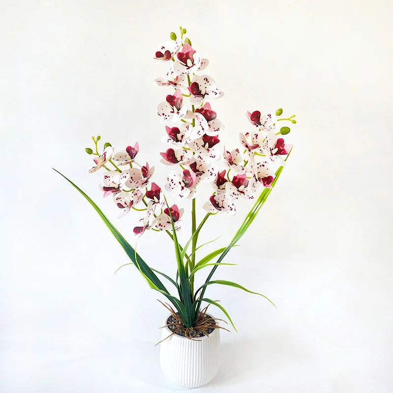 Artificial white orchid with burgundy spots in a white ribbed pot