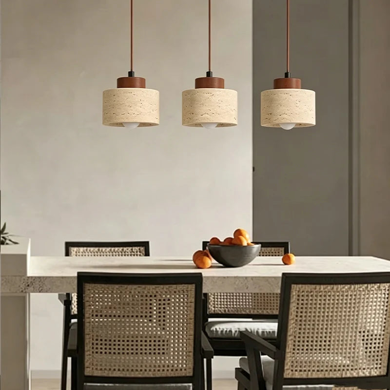 Three Pendant Light Dana travertine pendants above a dining table