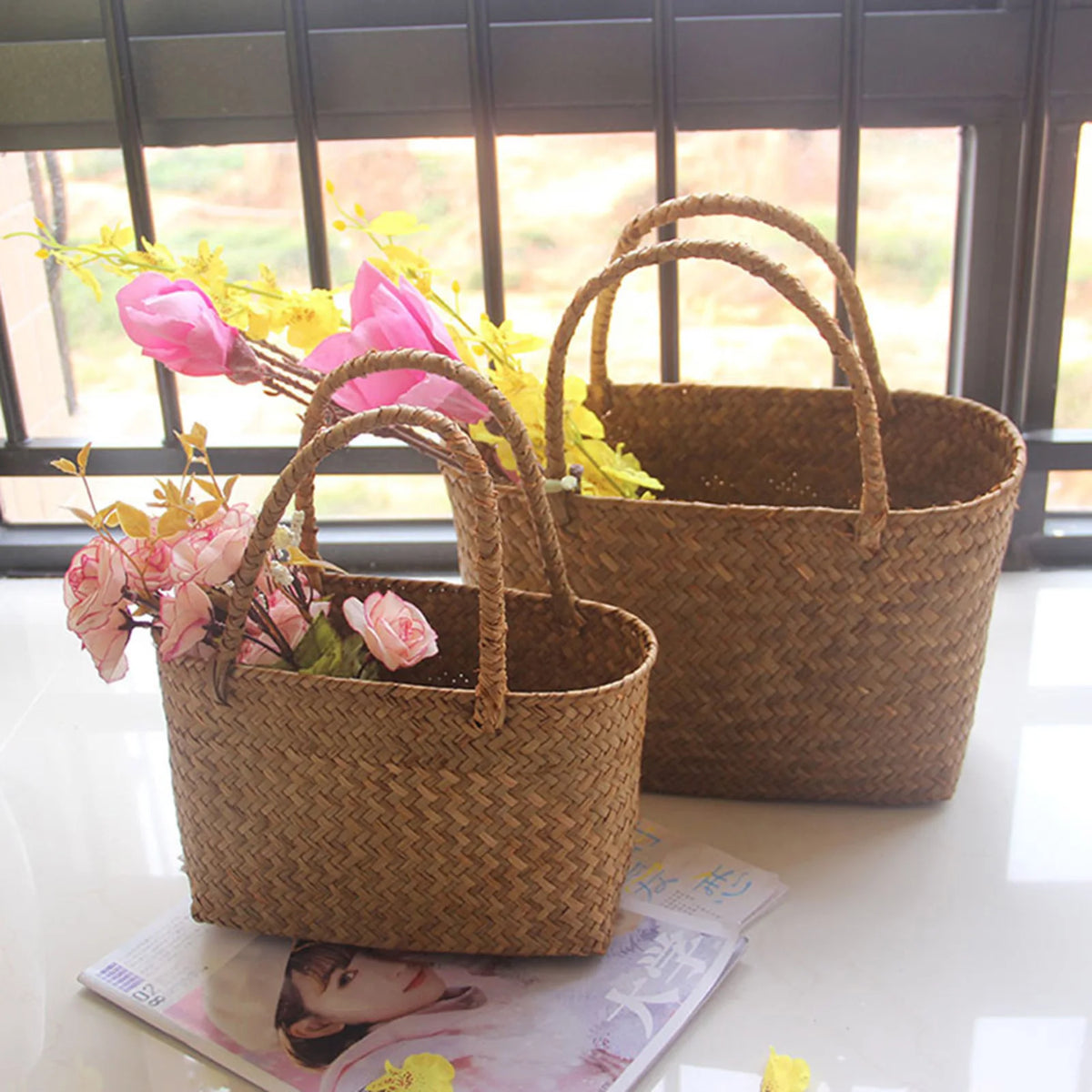 Seagrass baskets with pink flowers on a window sill