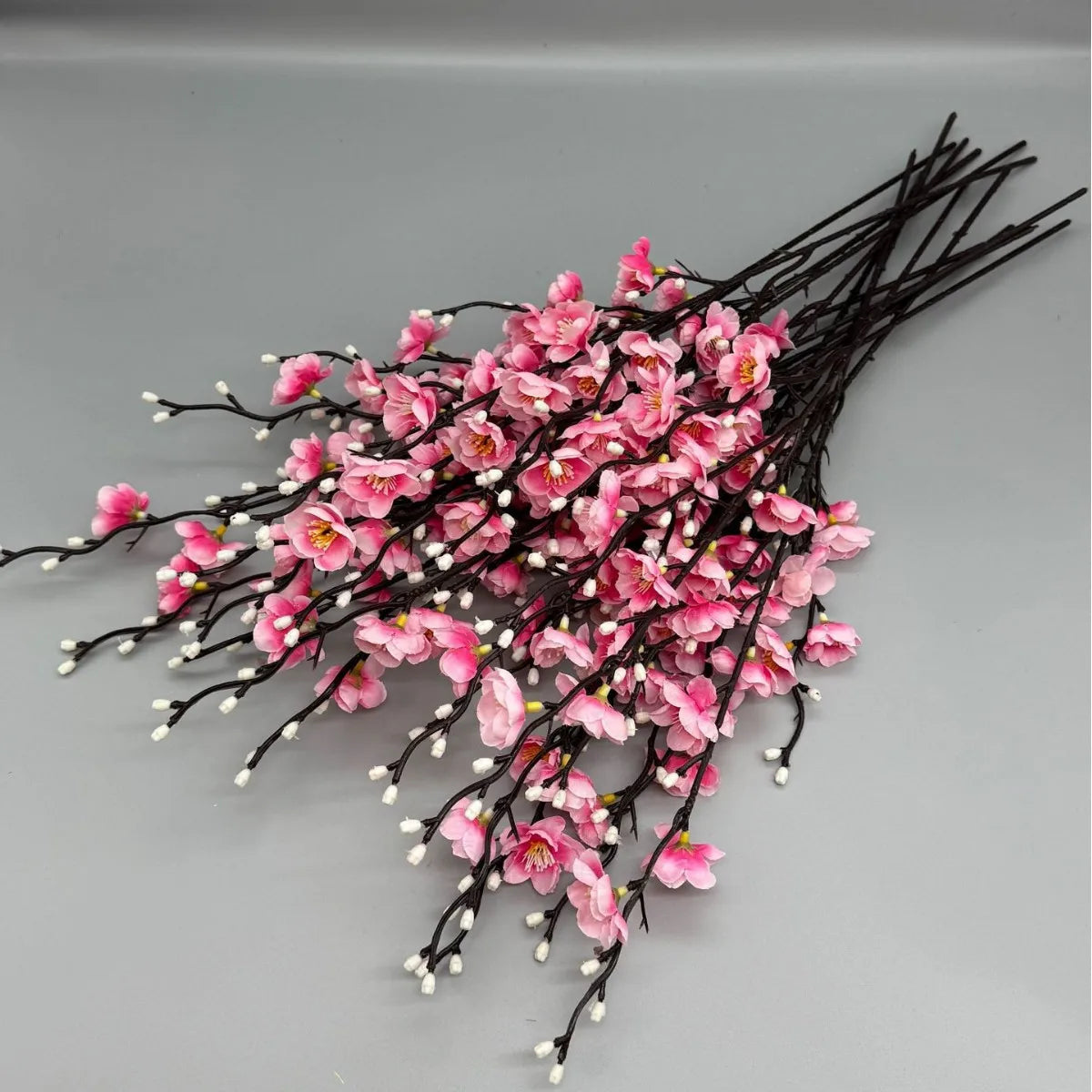 Bunch of pink faux plum blossom stems