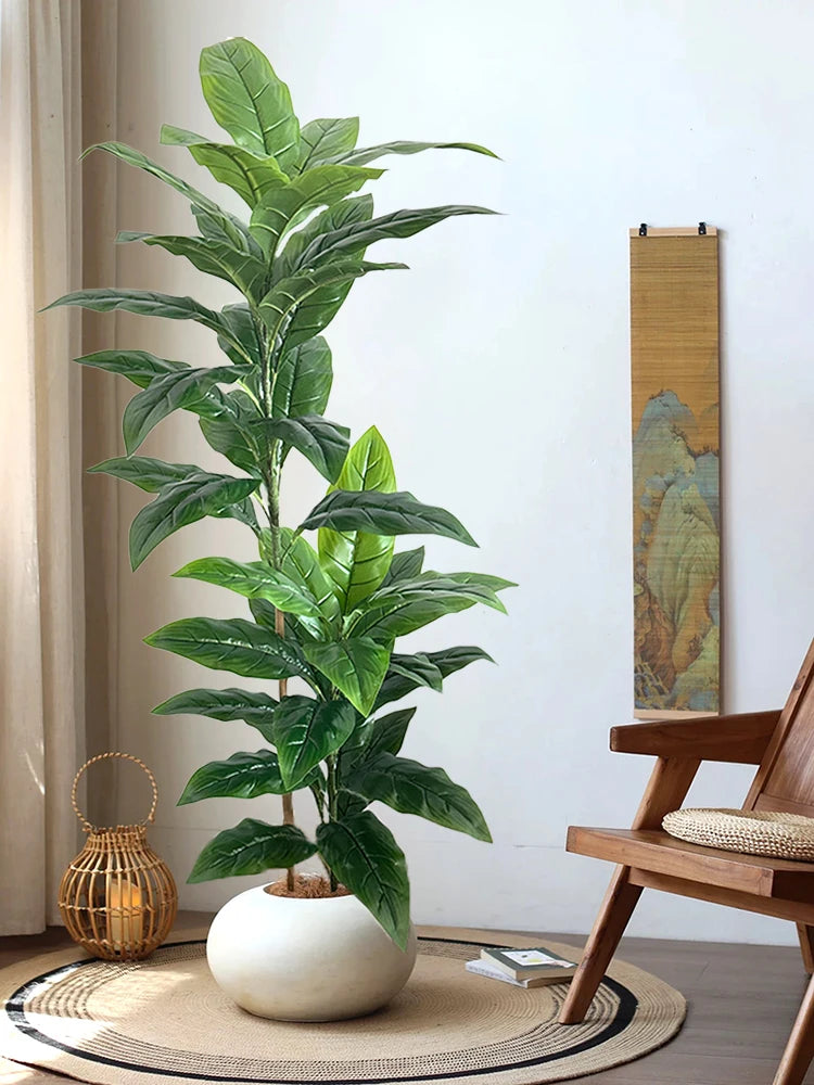 Artificial plant Andrea in a white pot beside a wooden chair