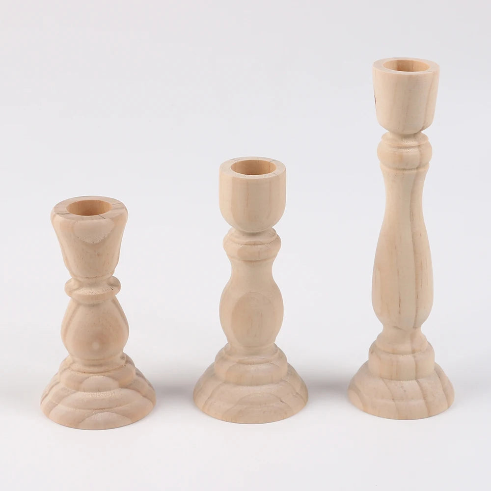 Small, medium and large unfinished beechwood candlesticks on a white studio background