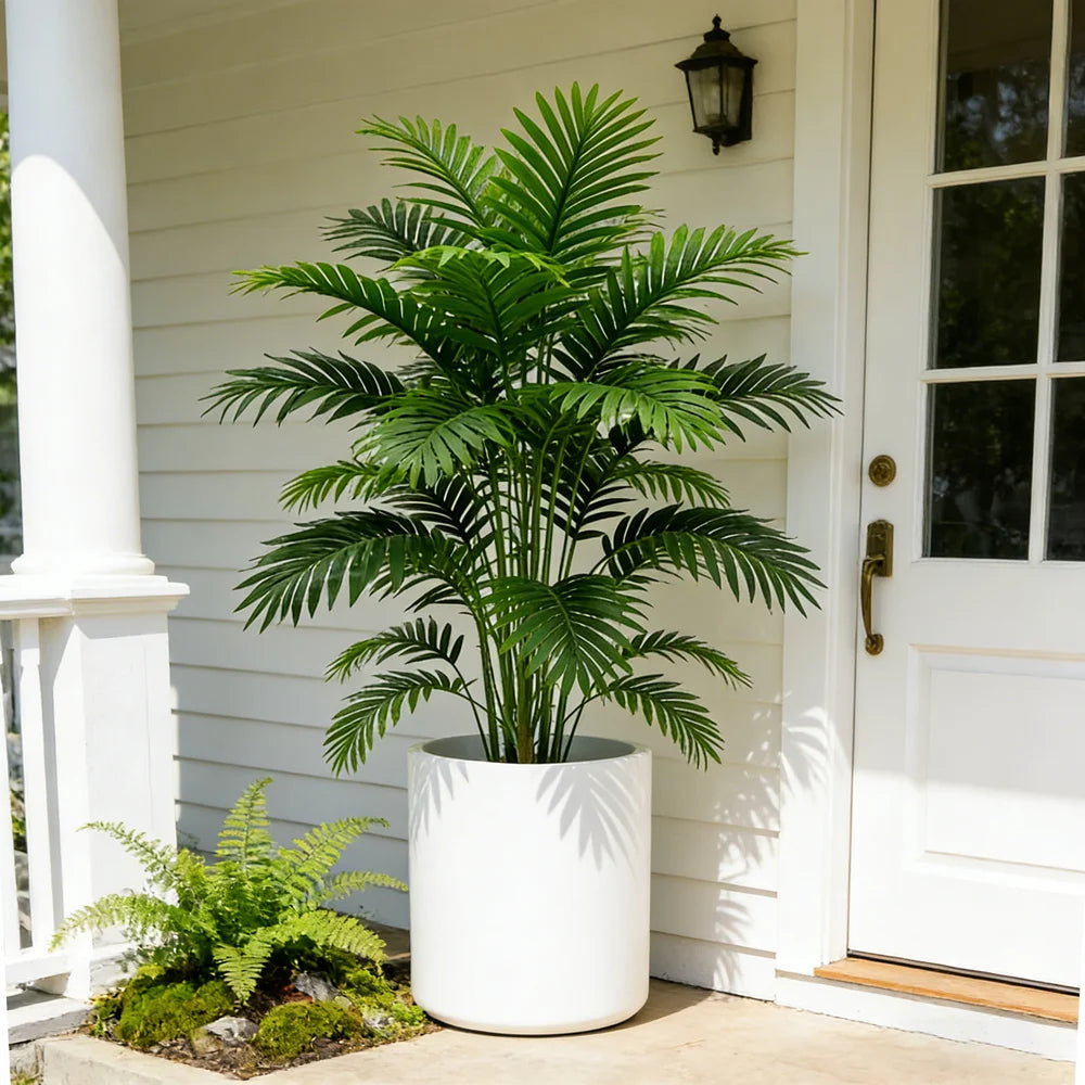 Artificial feathery palm Berta in a white pot by a door