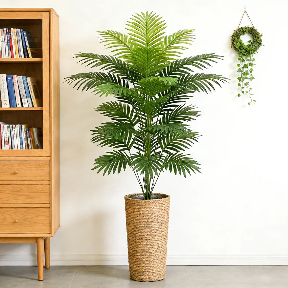 Artificial feathery palm Berta in a woven planter beside a shelf