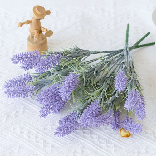 Artificial lavender bunch lying on a textured cloth