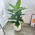 Artificial plant Andrea in a white pot in a bright room